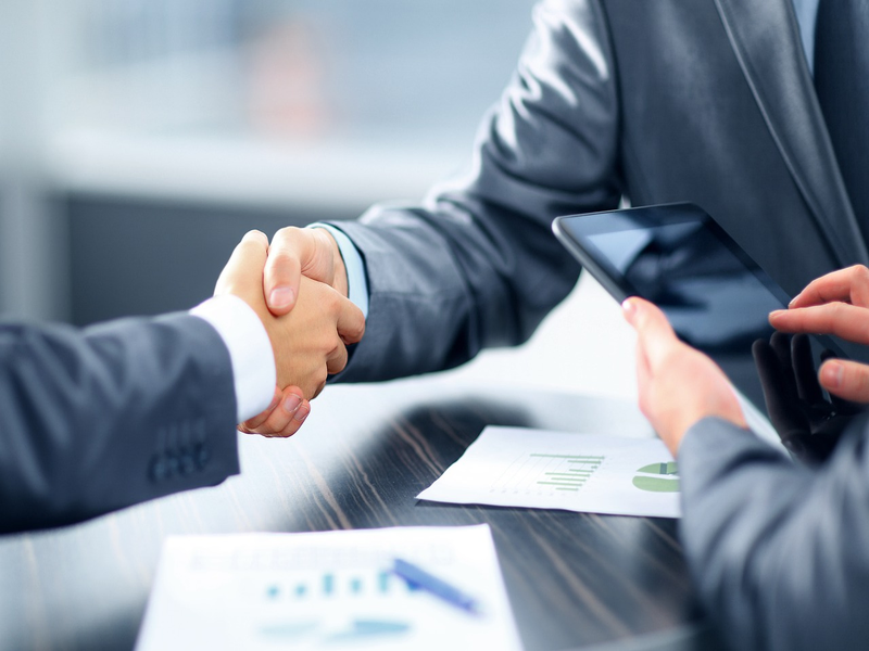 Two professionals in a discussion, signifying partnership.